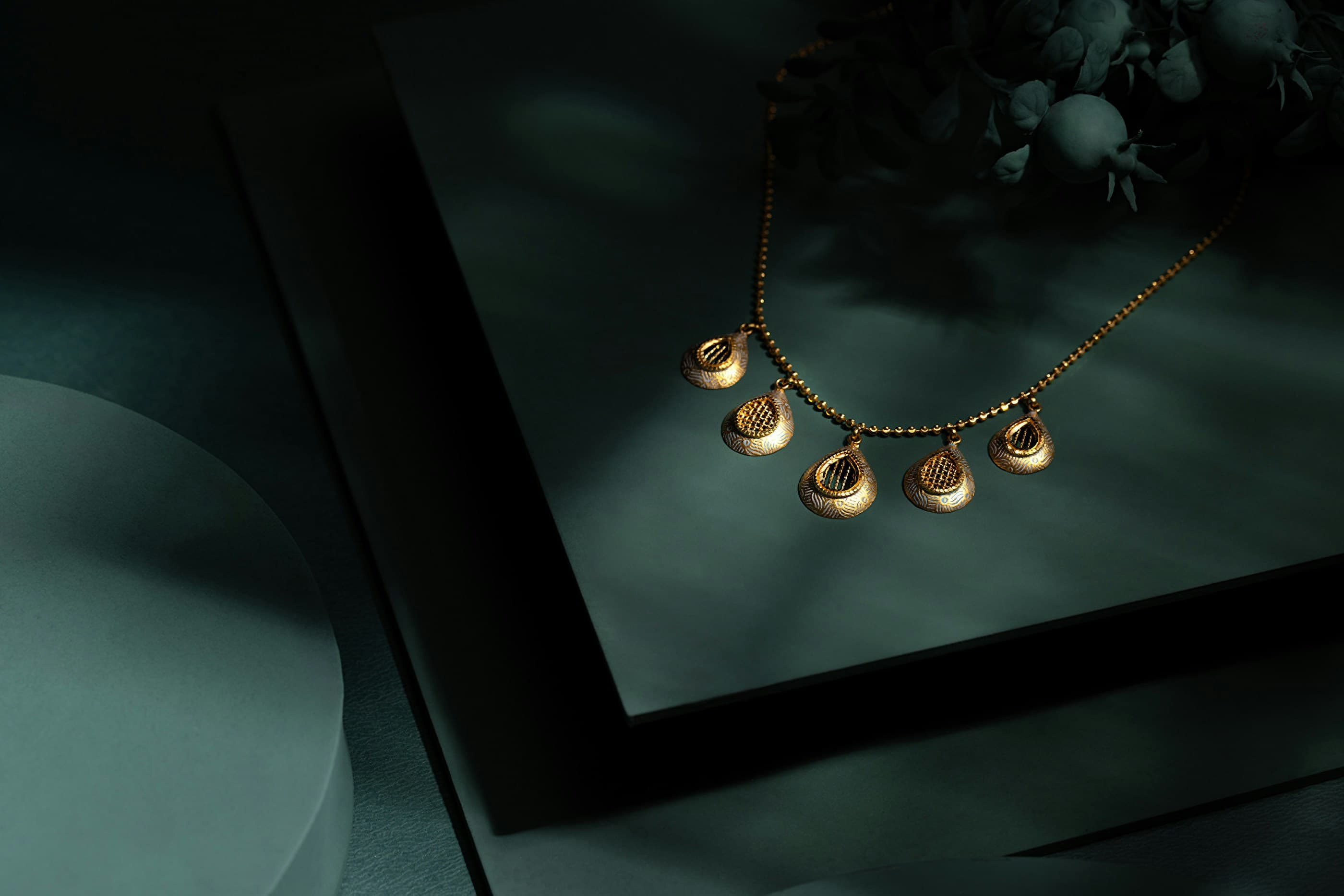 Layered fine gold chains, stacked rings, and a delicate cuff